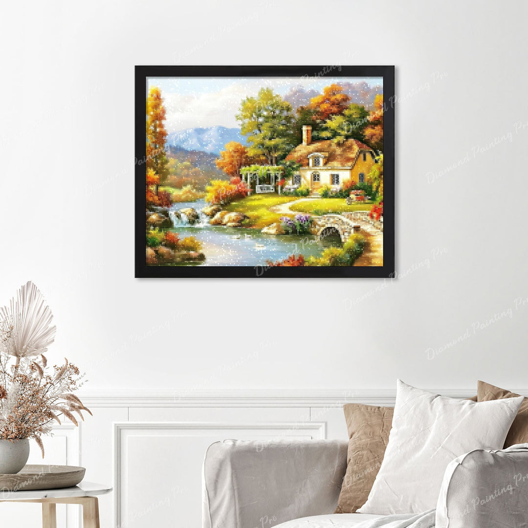 Autumn Cottage by the River Finished Diamond Painting Displayed with Black Frame as Home Decor