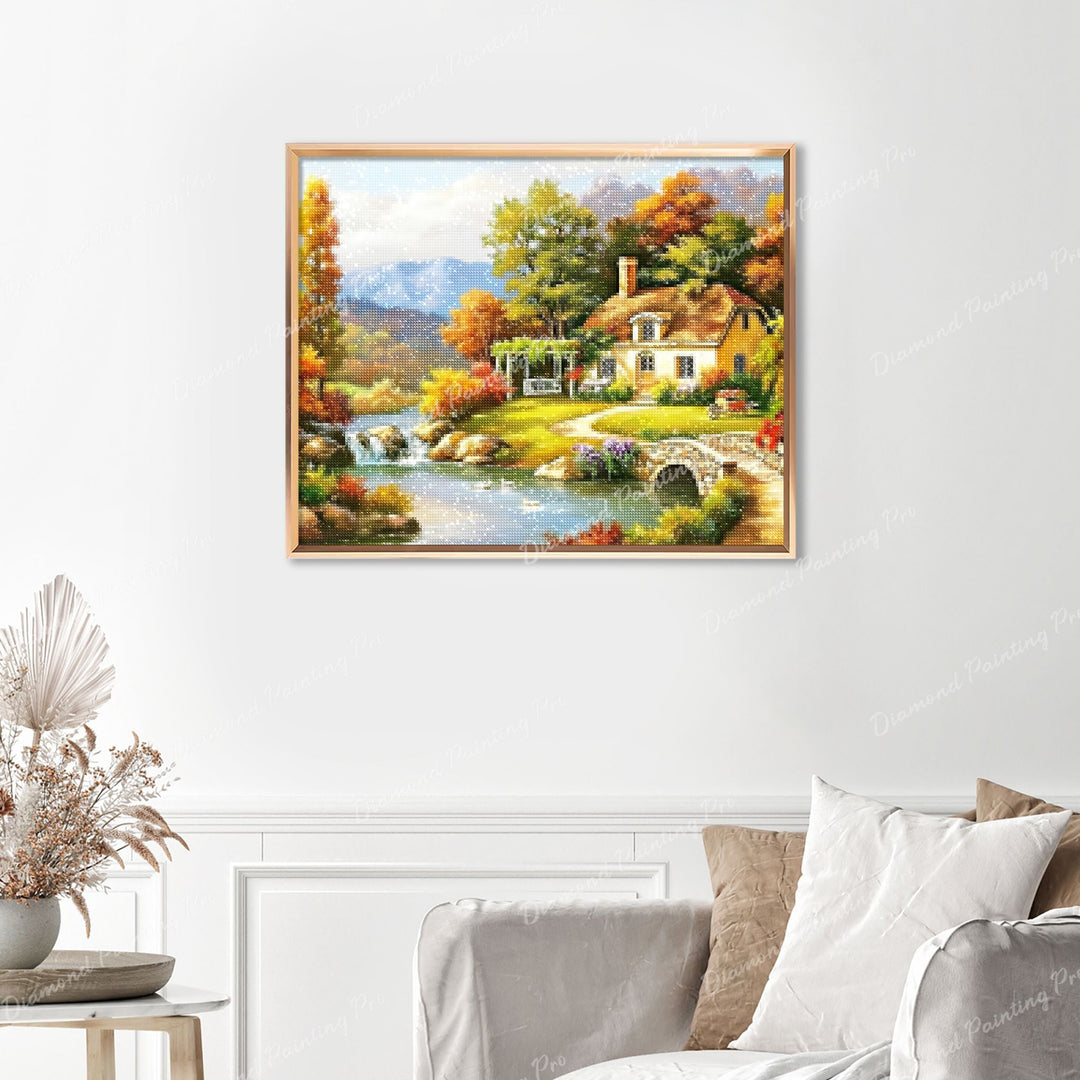 Autumn Cottage by the River Finished Diamond Painting Displayed with Gold Frame as Home Decor